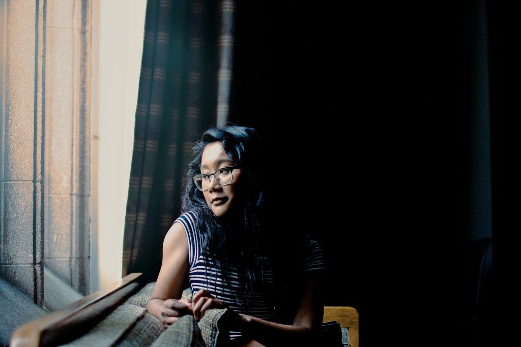 A women siting besides the window